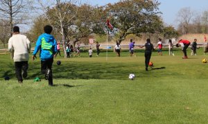 kids playing foot golf on a fieldtrip 