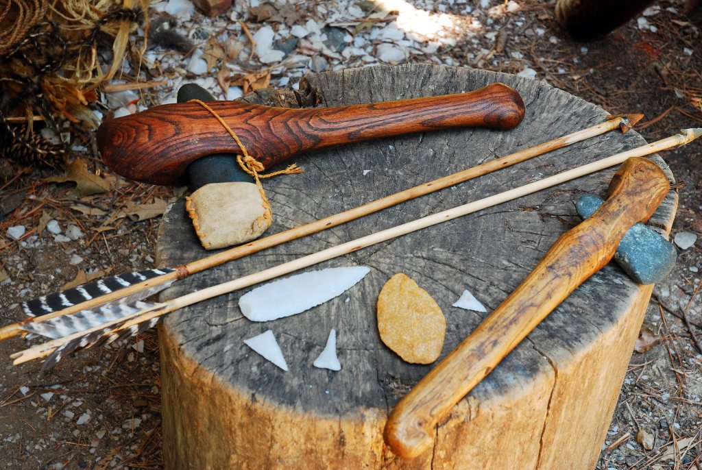 Ancient Tools Laying On A Cut Tree Trunk.